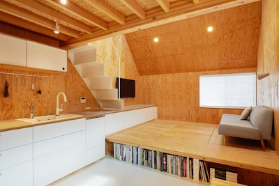 Open plan living with changing floor heights to defines separate zones for lounge and kitchen/dining.